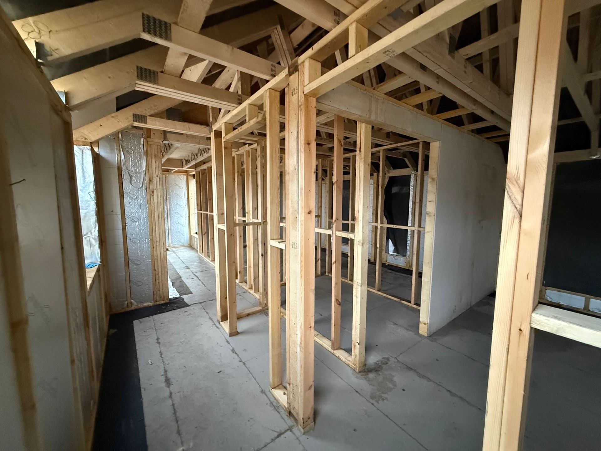 Stud partitions and roof structure across the upper floor of the Airbnb project