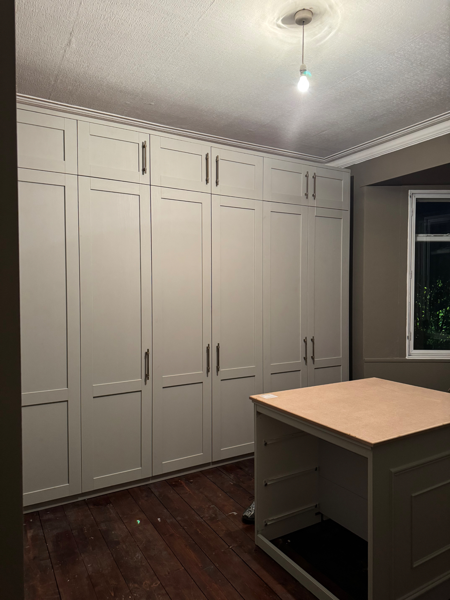 Angled view of fitted wardrobes with overhead cupboards and island