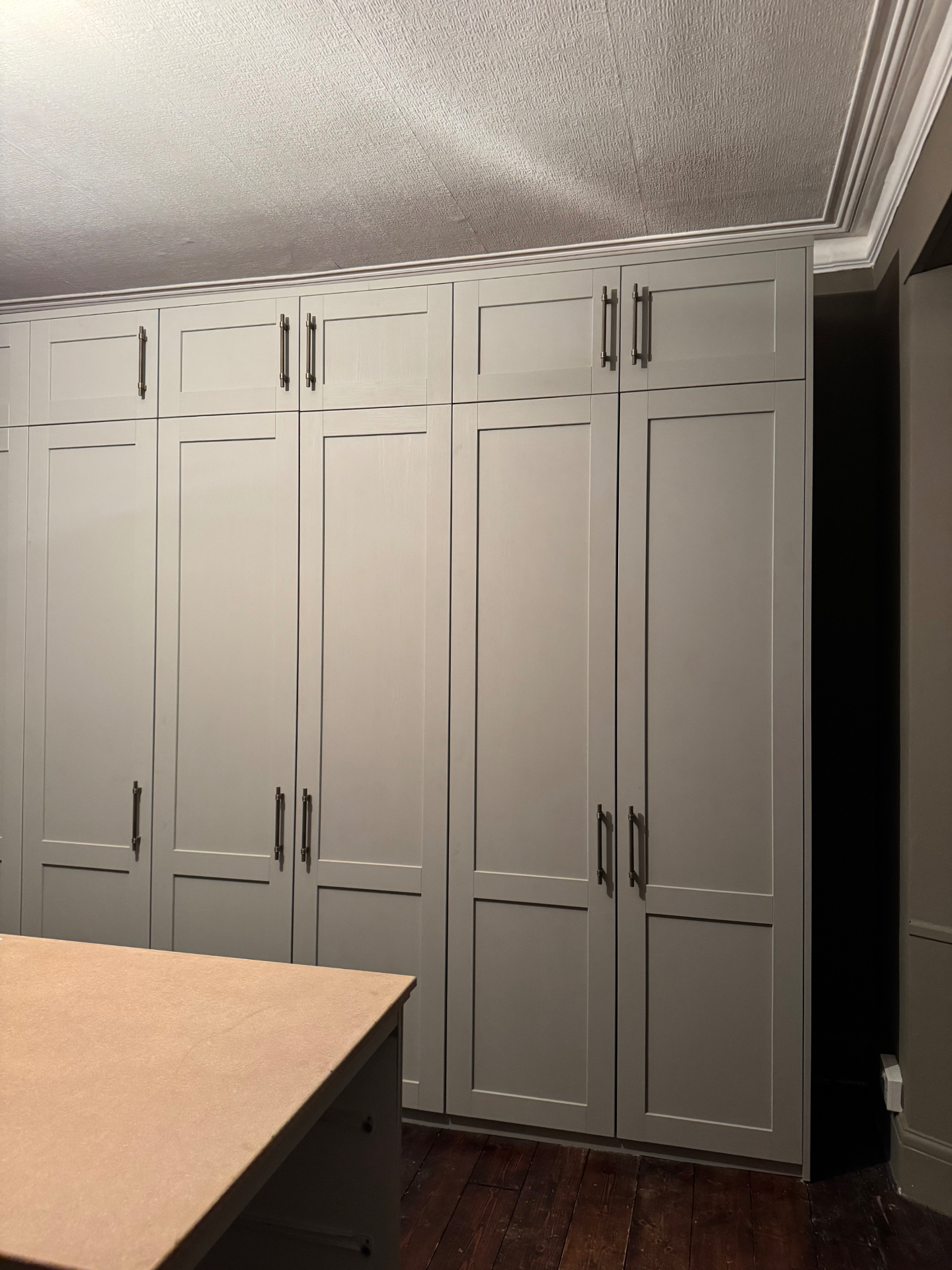 Close view of fitted wardrobe bank with painted shaker doors
