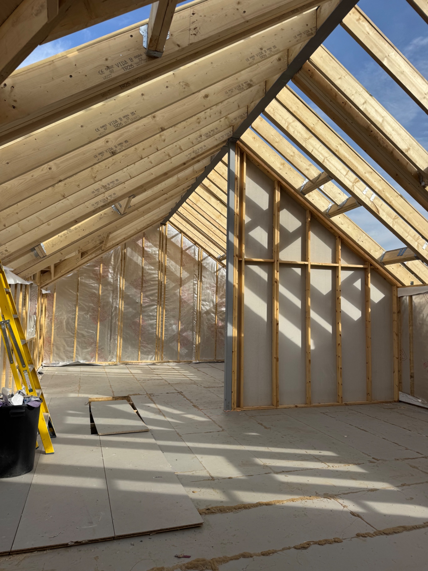 Open roof space showing rafters at the Rhos build