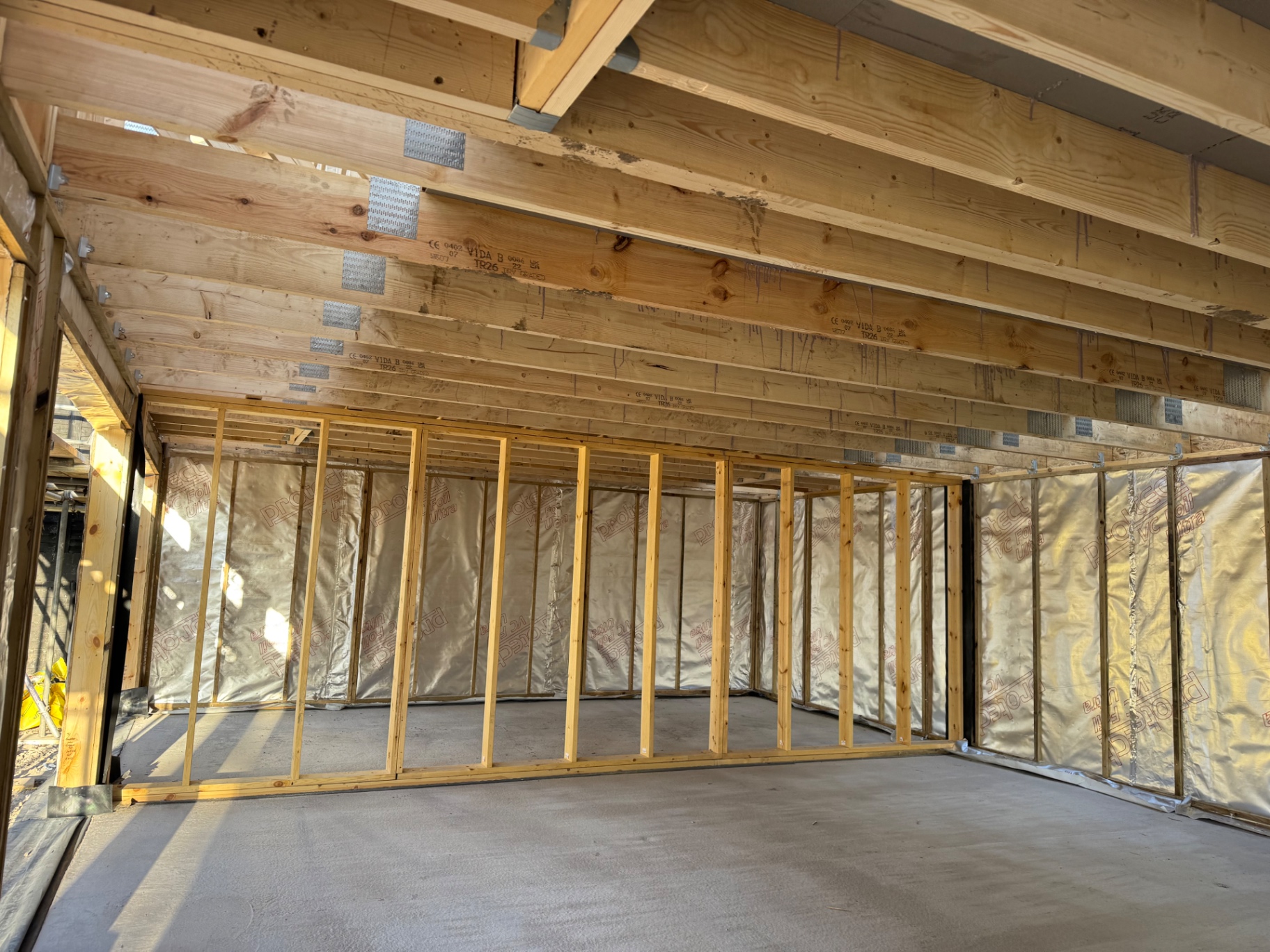 Ground floor interior of triple garage showing timber joists and studwork