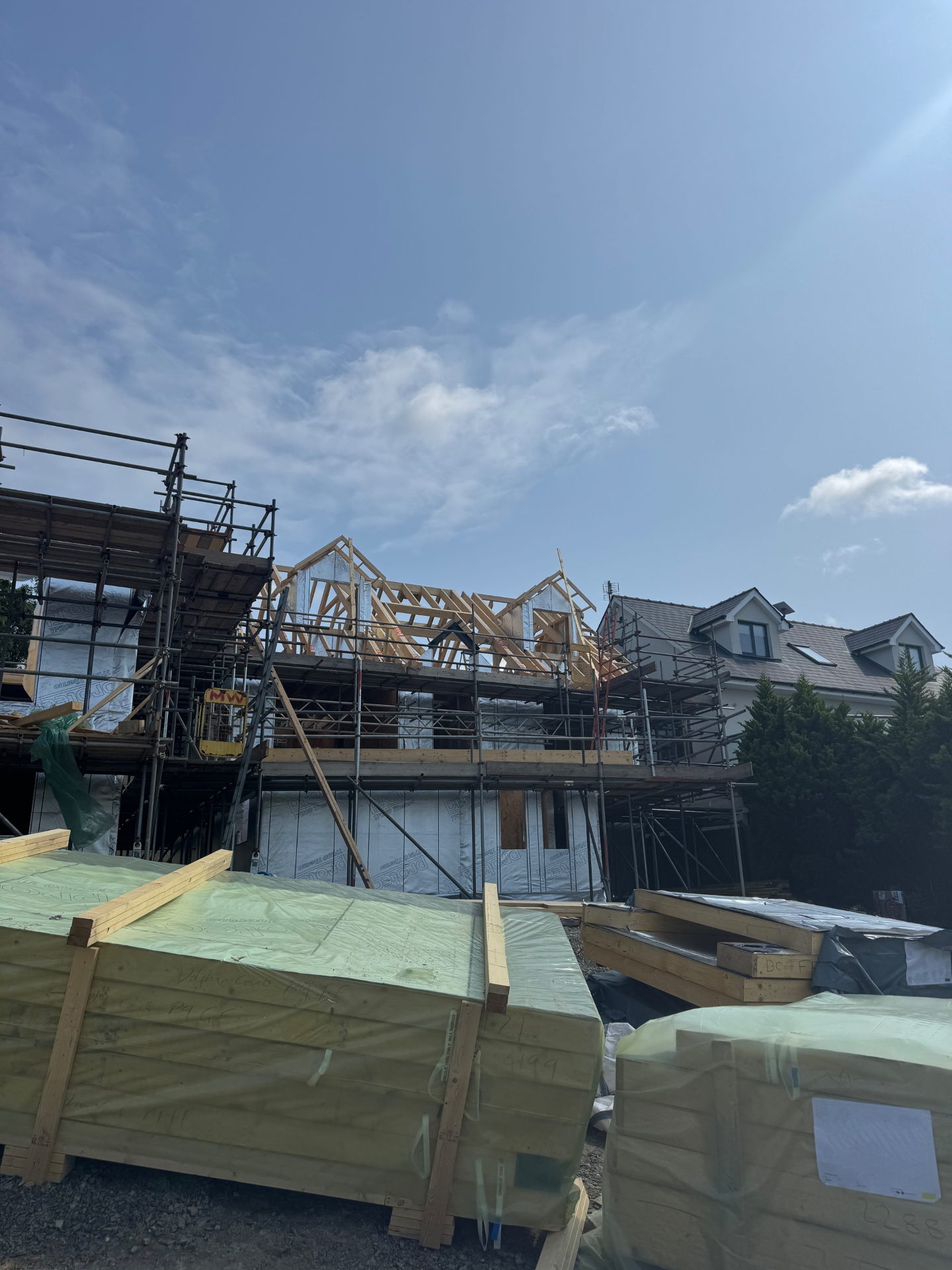 Cut roof and dormer framing taking shape on a New Quay plot