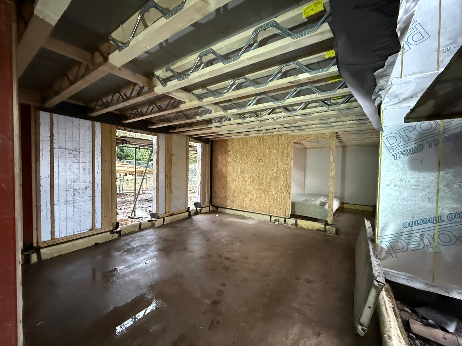 Ground floor framing with insulated walls and engineered floor system above
