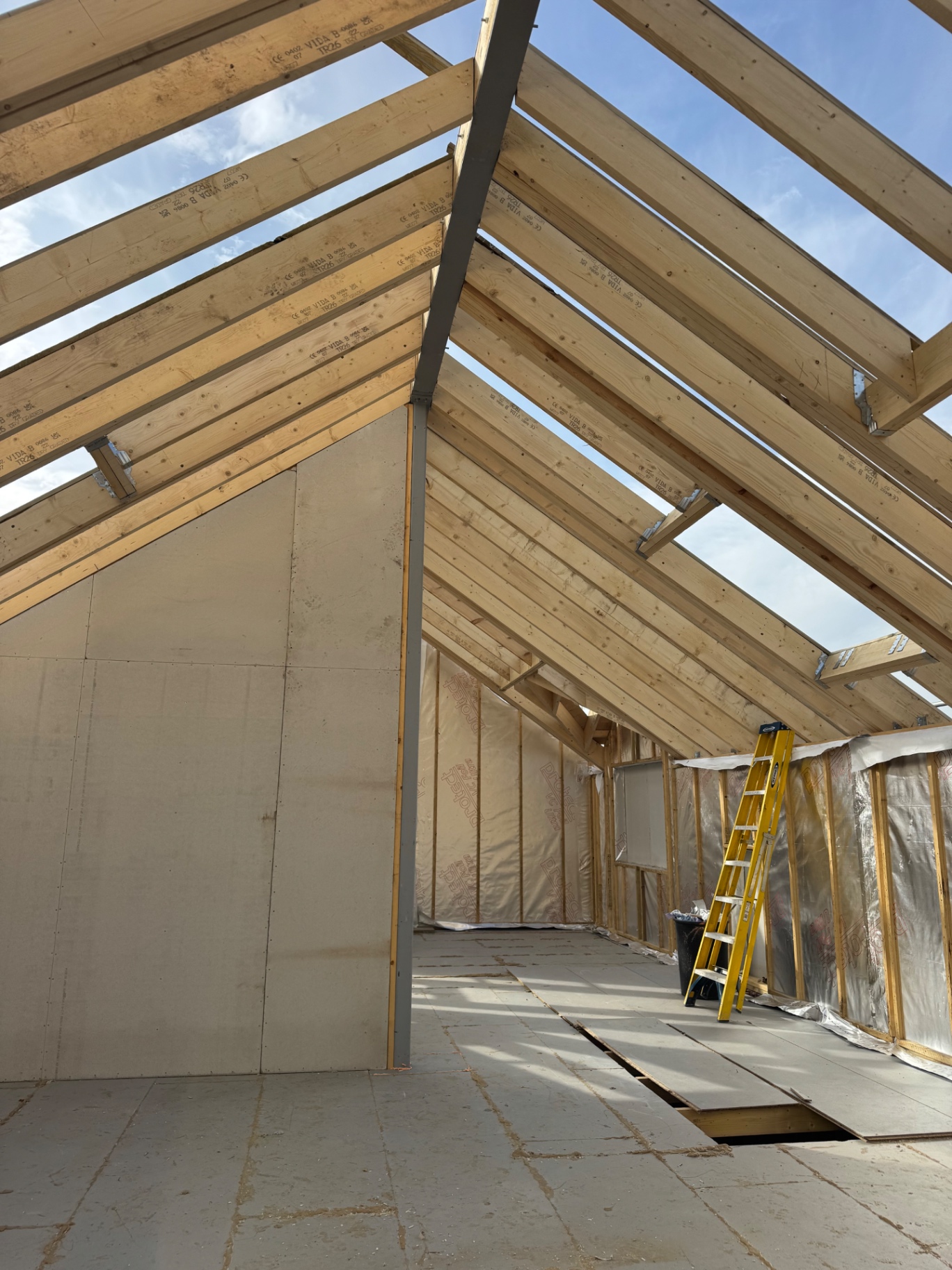 Wide interior view of the completed roof structure and partitions at the Rhos build