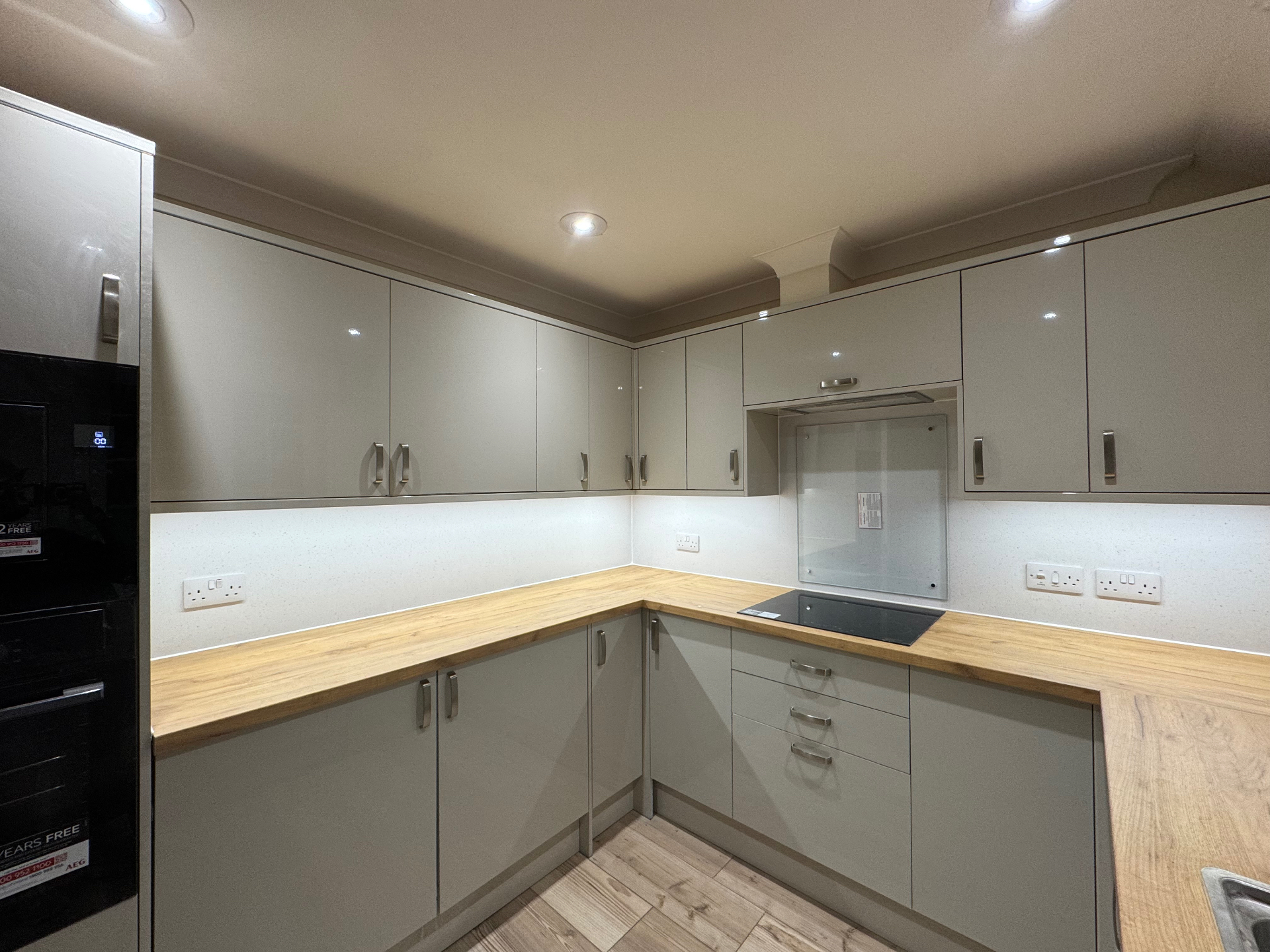 Angled evening view of the Mumbles Reno kitchen with bright task lighting