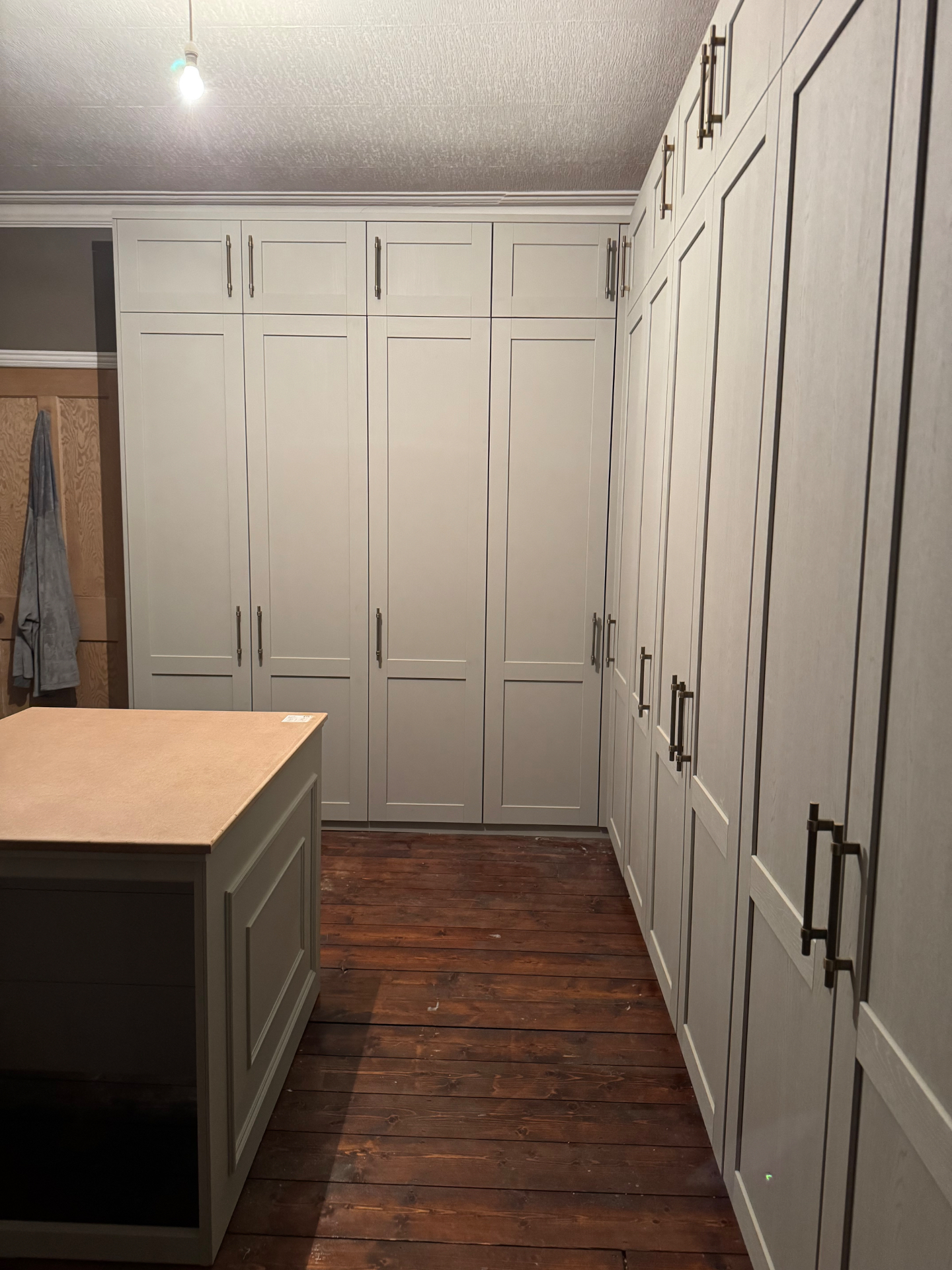 Full room view of built-in wardrobes wrapping the space