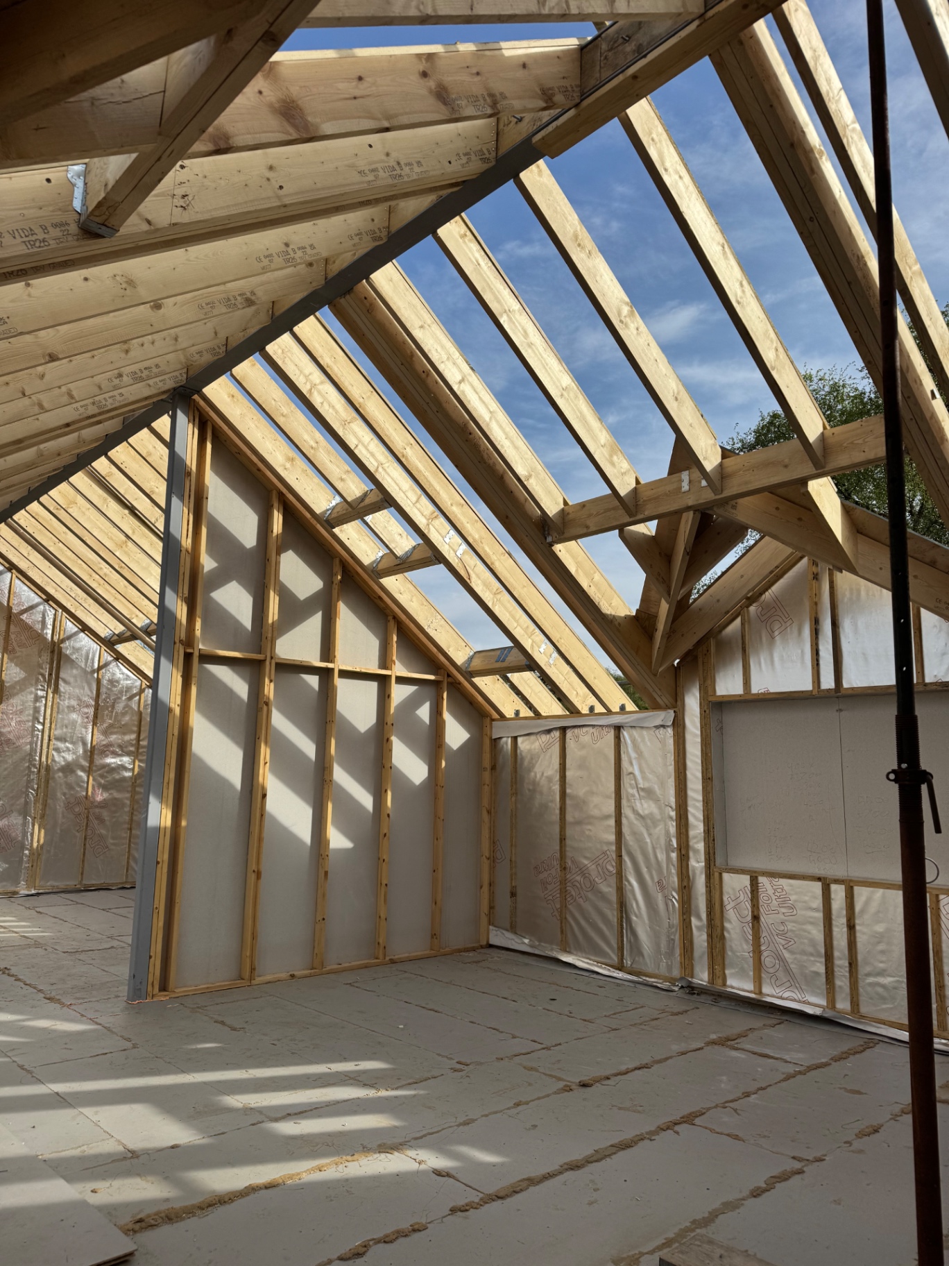 Interior framing and gable end studwork at the Rhos build