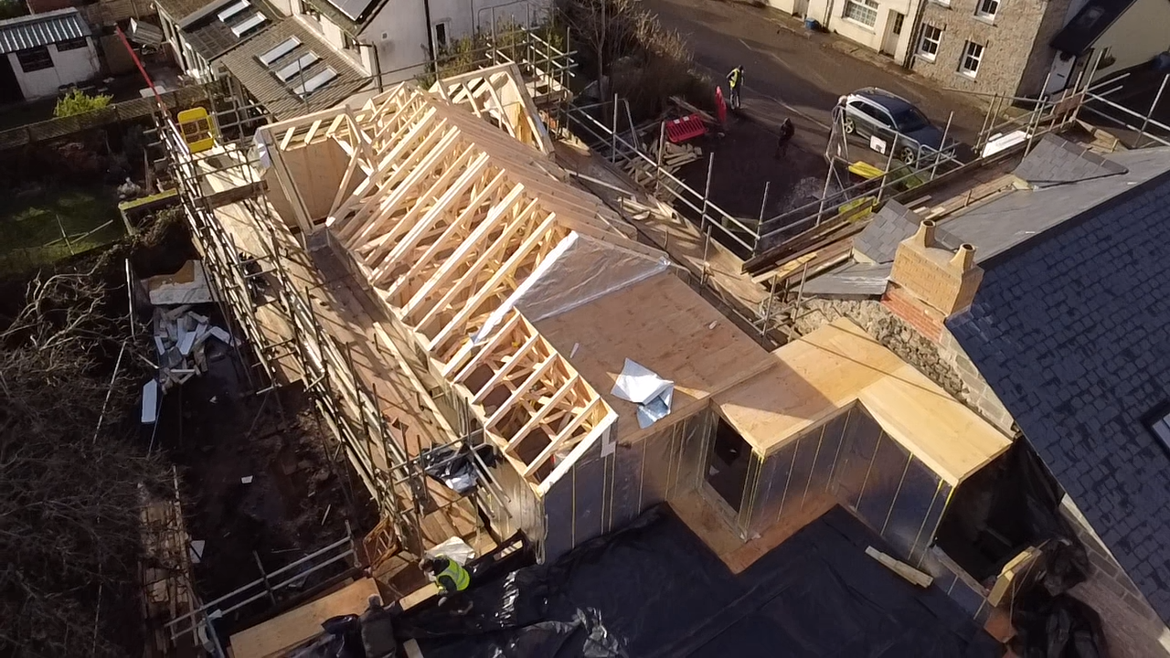 Aerial view of the Airbnb conversion showing newly framed cut roof structure over the property