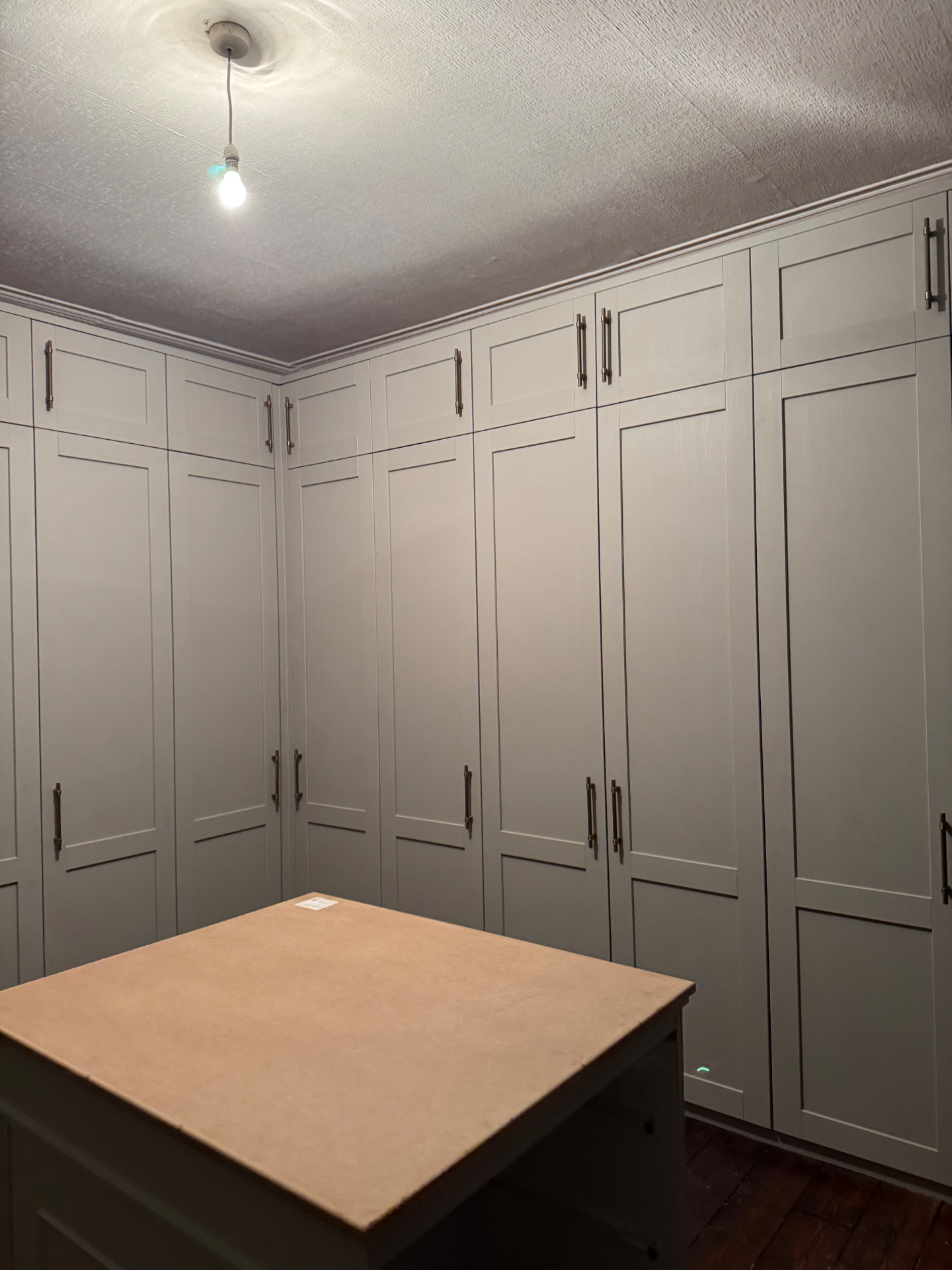 Corner detail of fitted wardrobes and overhead storage