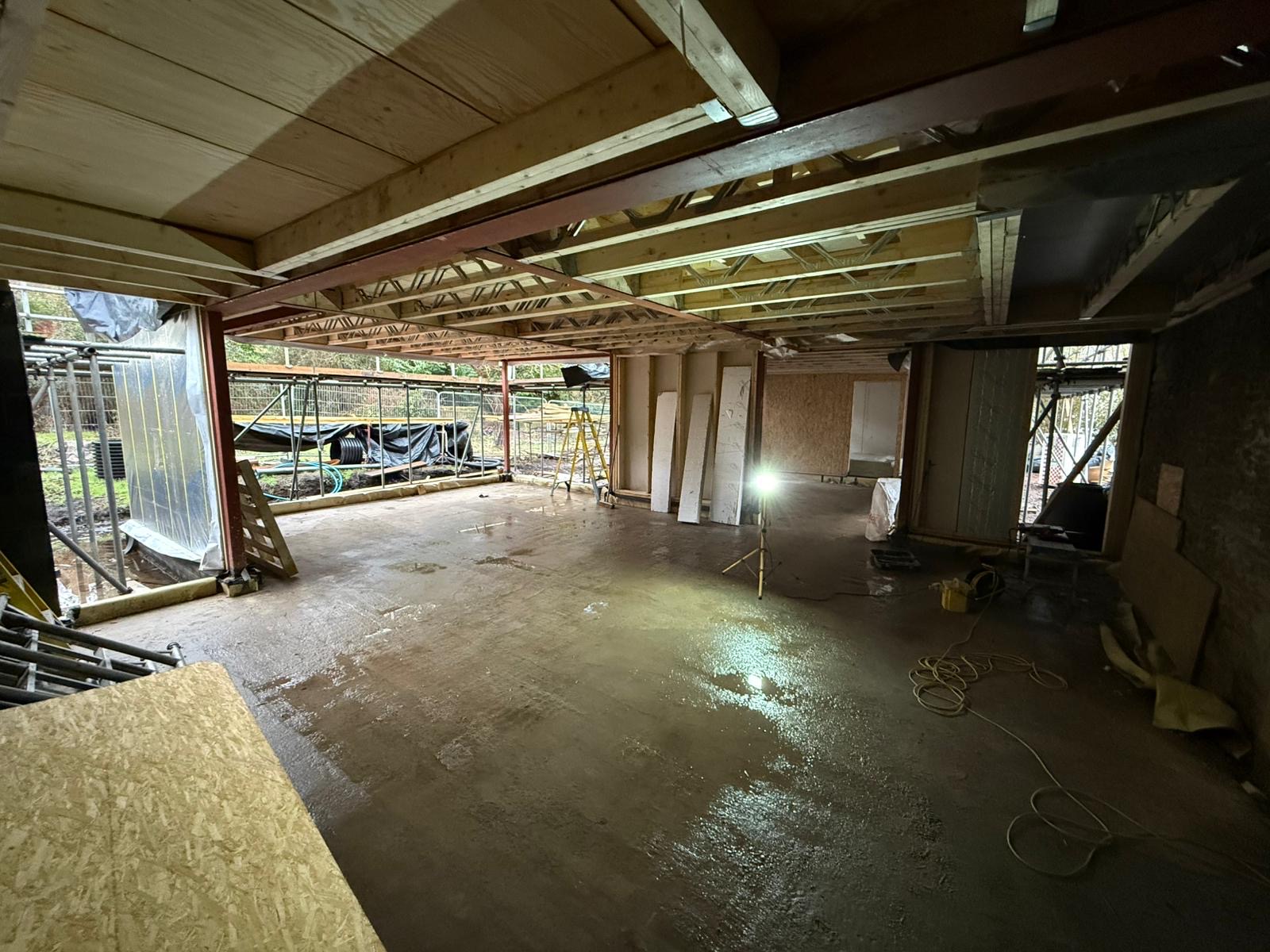 Ground floor open-plan space with steel beams and engineered floor joists on the Airbnb project