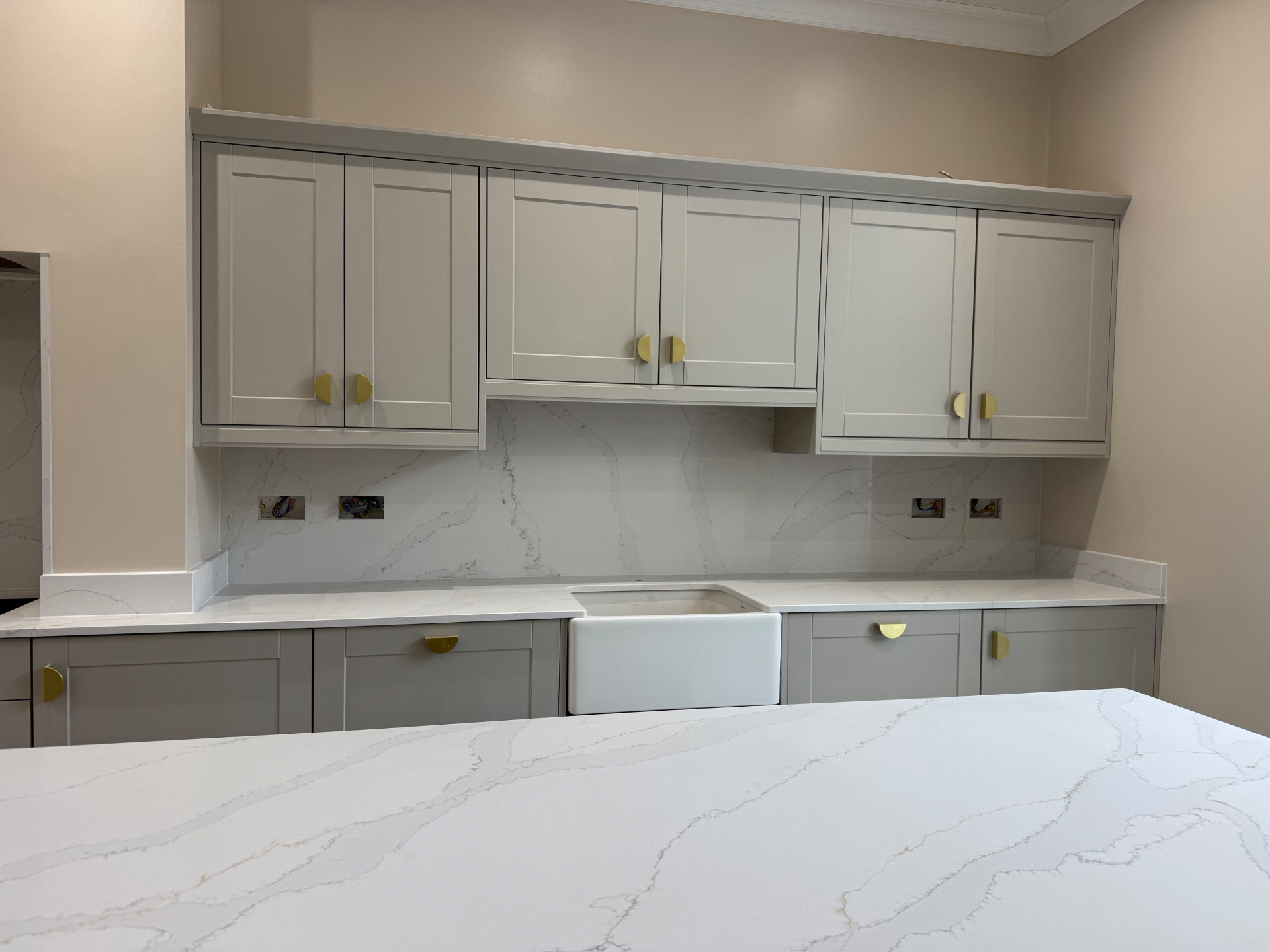 Front view of the Reno project kitchen cabinetry and Belfast sink detail